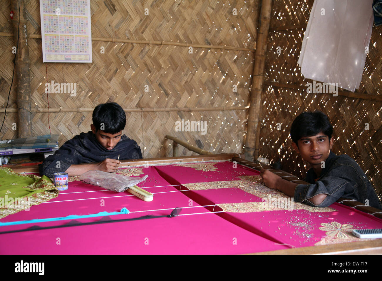Teenager working on the decoration of textiles in Kumrokhali, India on Jan 16, 2009. Stock Photo