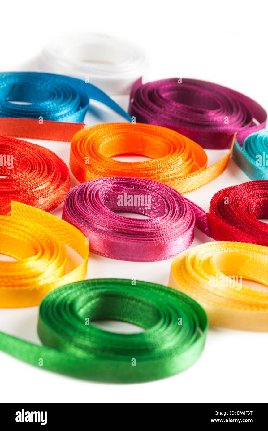 Coiled spools of colorful ribbons on a white background Stock Photo - Alamy