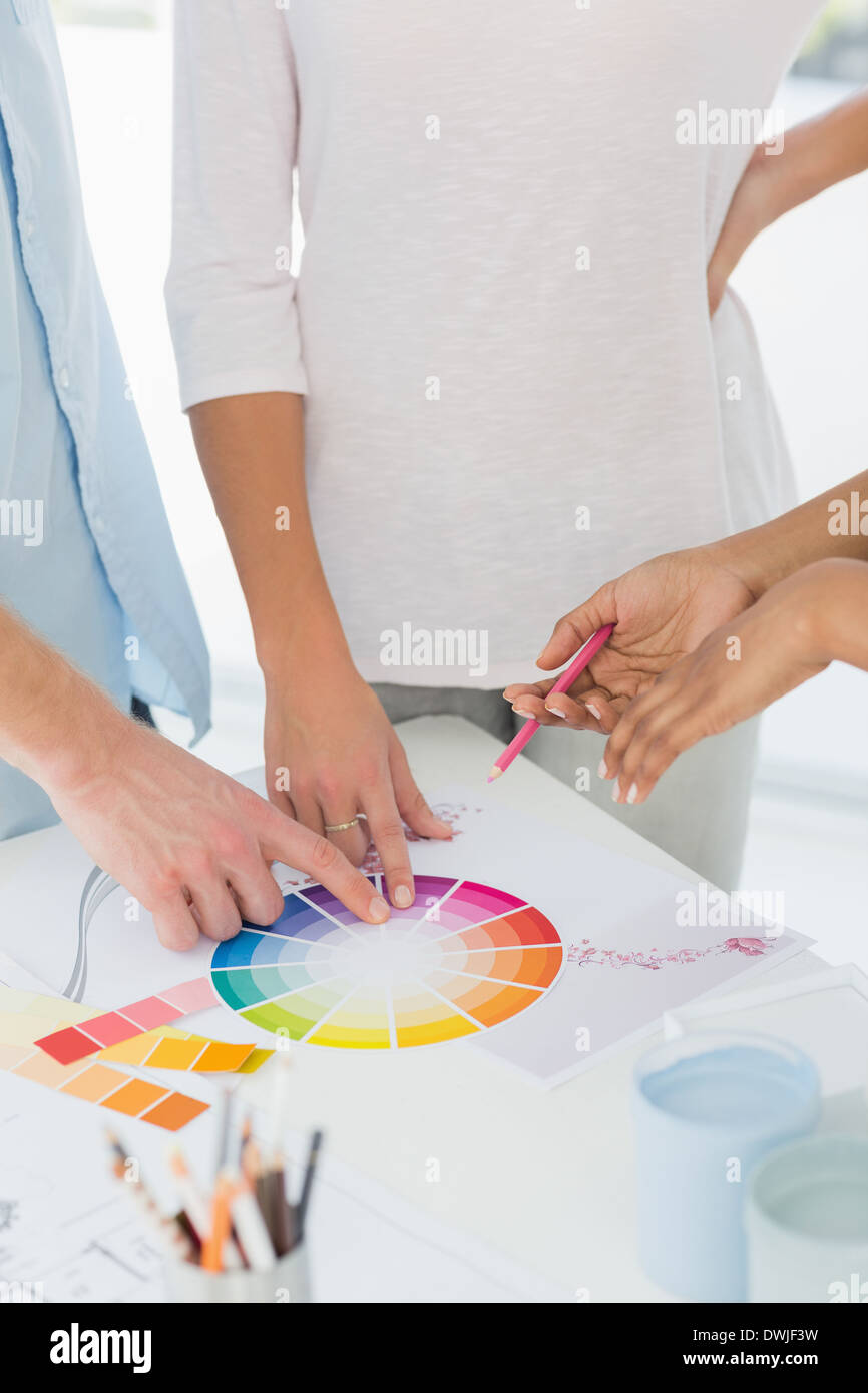 Interior designer showing colour wheel to two customers Stock Photo