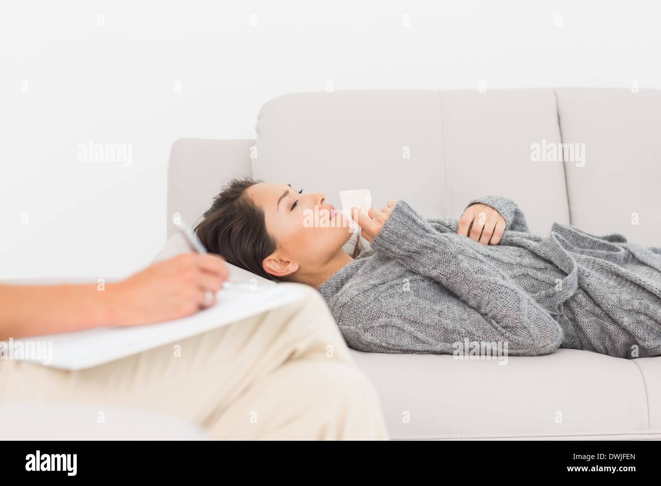 Therapist taking notes on her crying patient on the couch Stock Photo