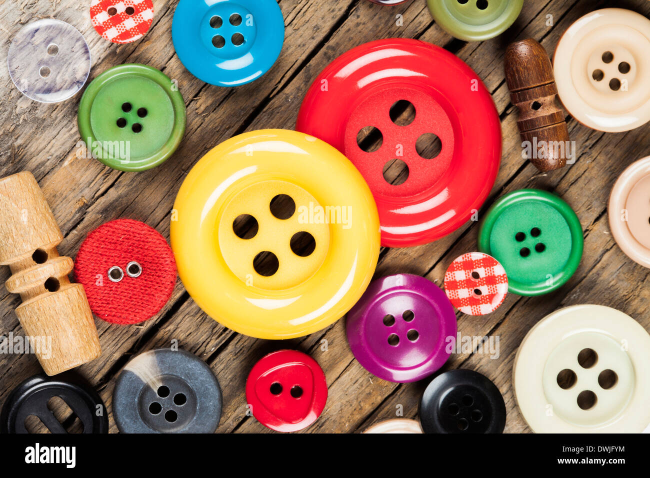 Set of colored sewing buttons on wooden background Stock Photo - Alamy