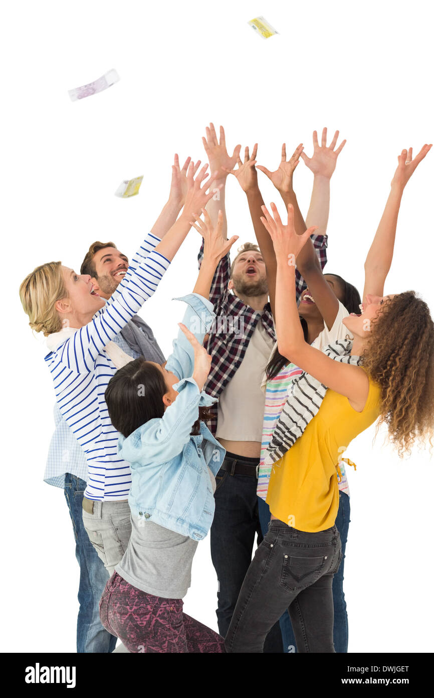 Happy group of young friends throwing money in the air Stock Photo Alamy