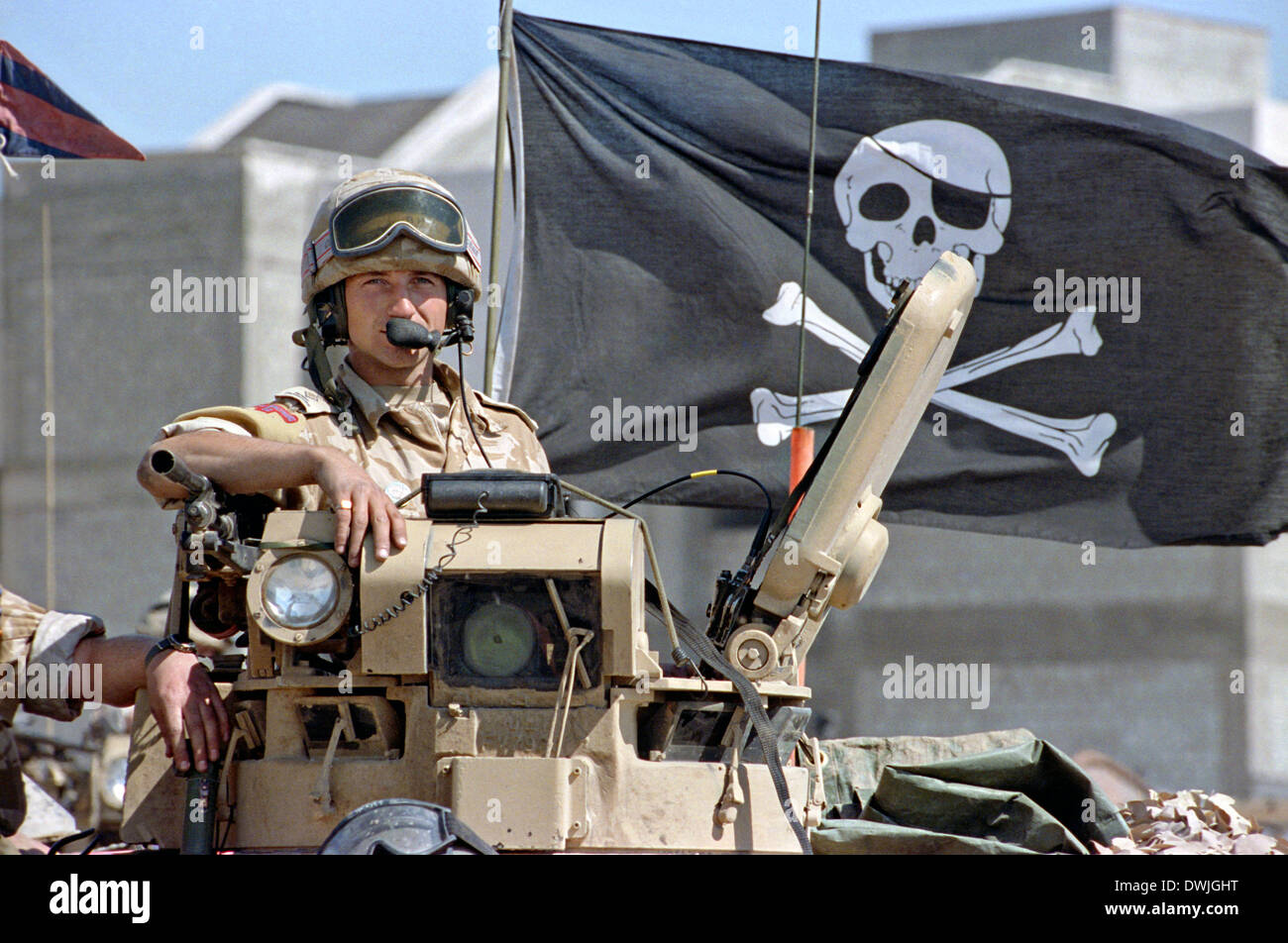 A British army soldier displays a Jolly Rogers pirate flag from his Ferret armoured scout car during the Persian Gulf War February 24, 1991 in Saudi Arabia. Stock Photo
