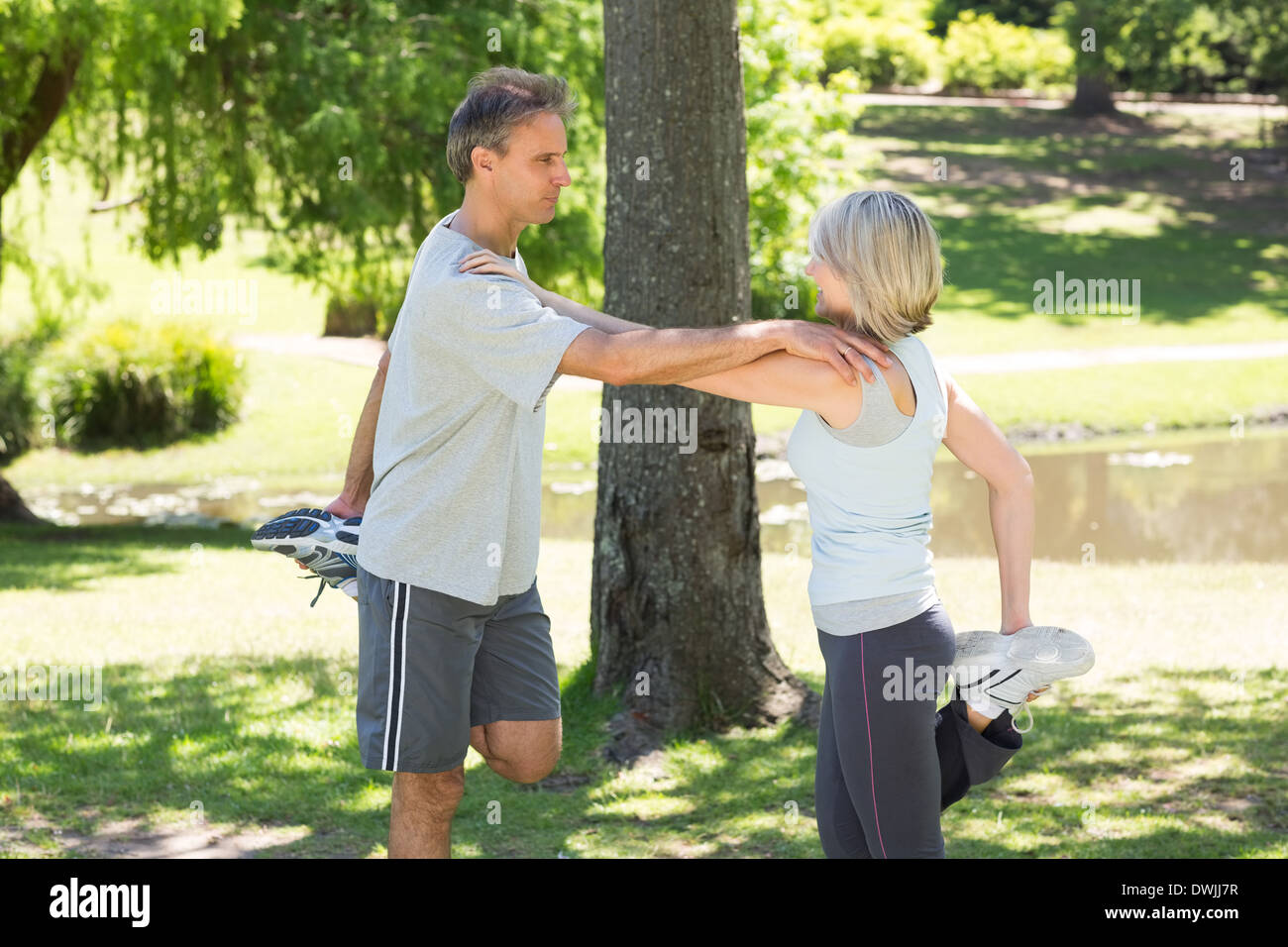 Couple stretching legs in park Stock Photo