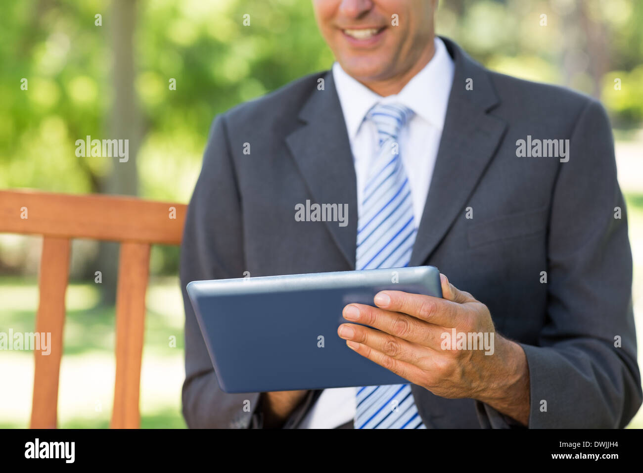Midsection of businessman using digital tablet Stock Photo