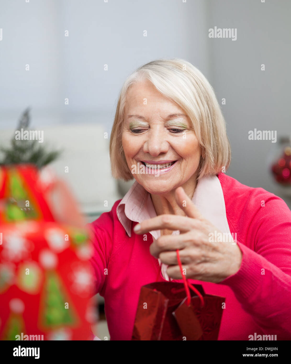 Senior Woman With Christmas Gift Stock Photo