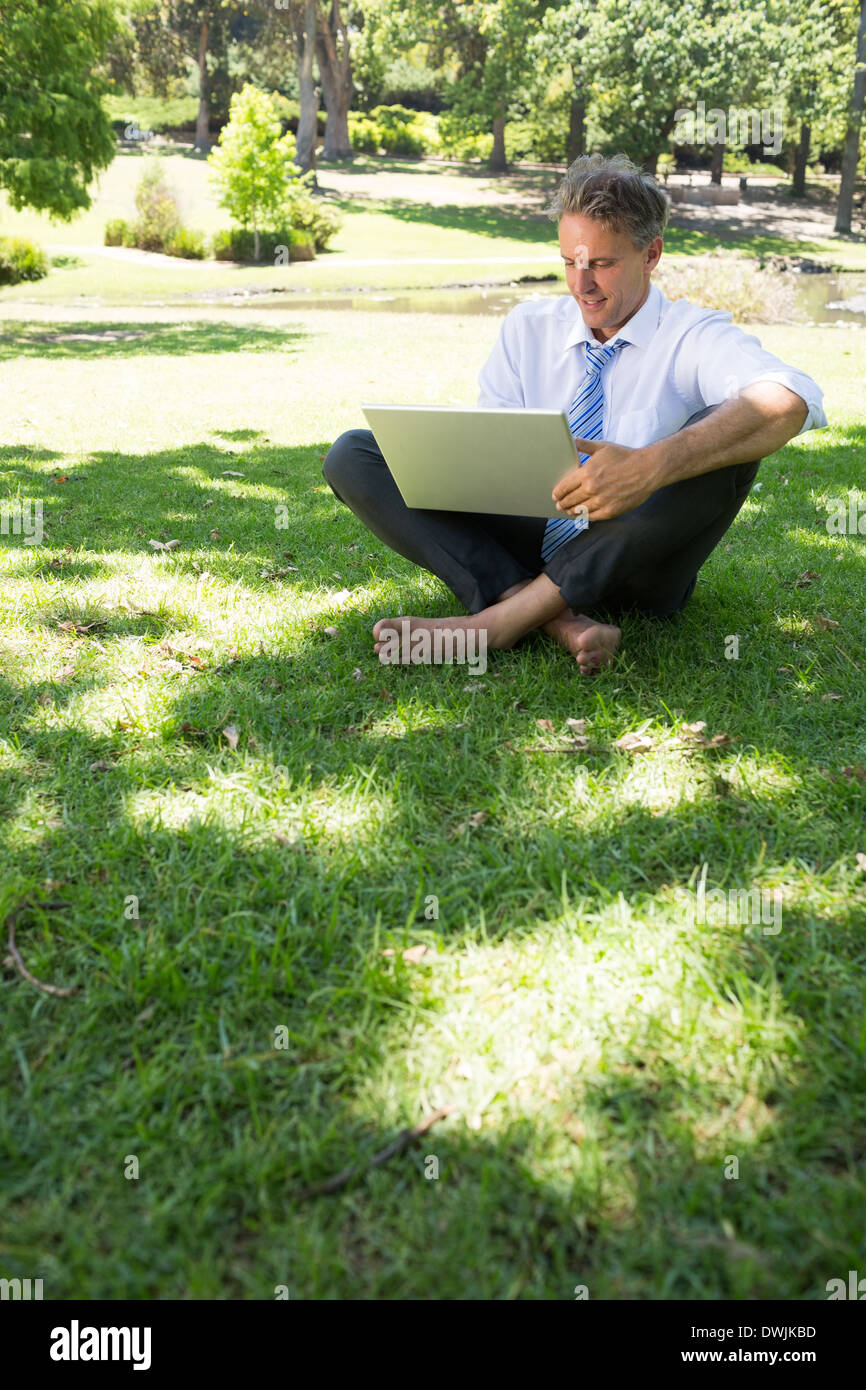 Businessman using laptop outdoors Stock Photo