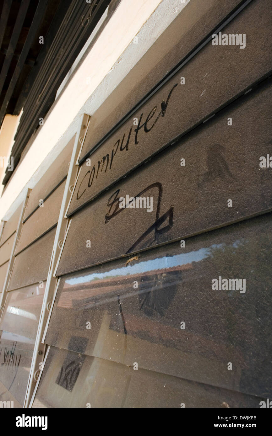 The word computer is written on a dusty louvered glass window at the University of Agriculture in Kampong Cham, Cambodia. Stock Photo