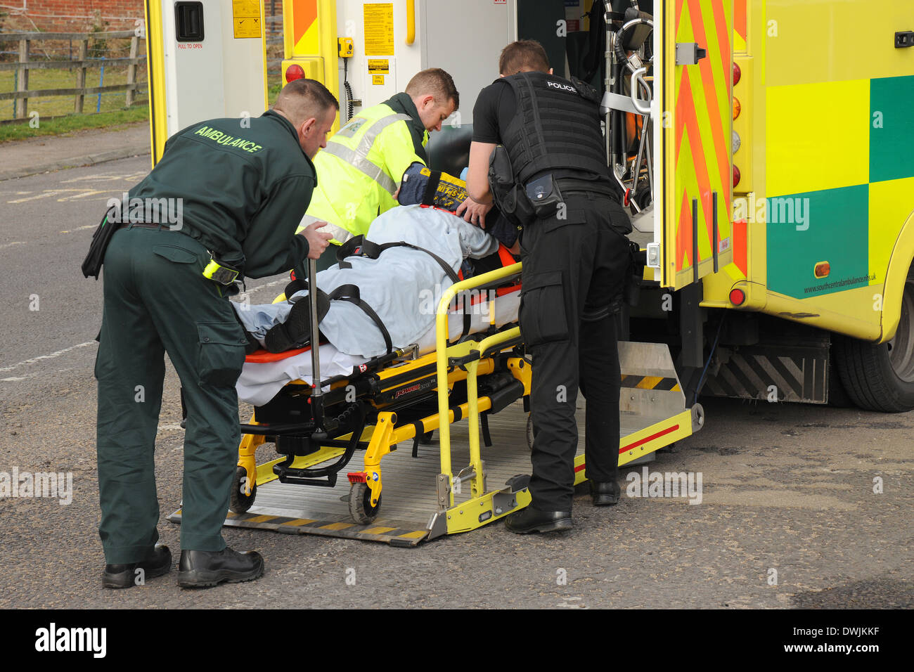 A road traffic accident casualty is tended to by ambulance crew and police officers Stock Photo