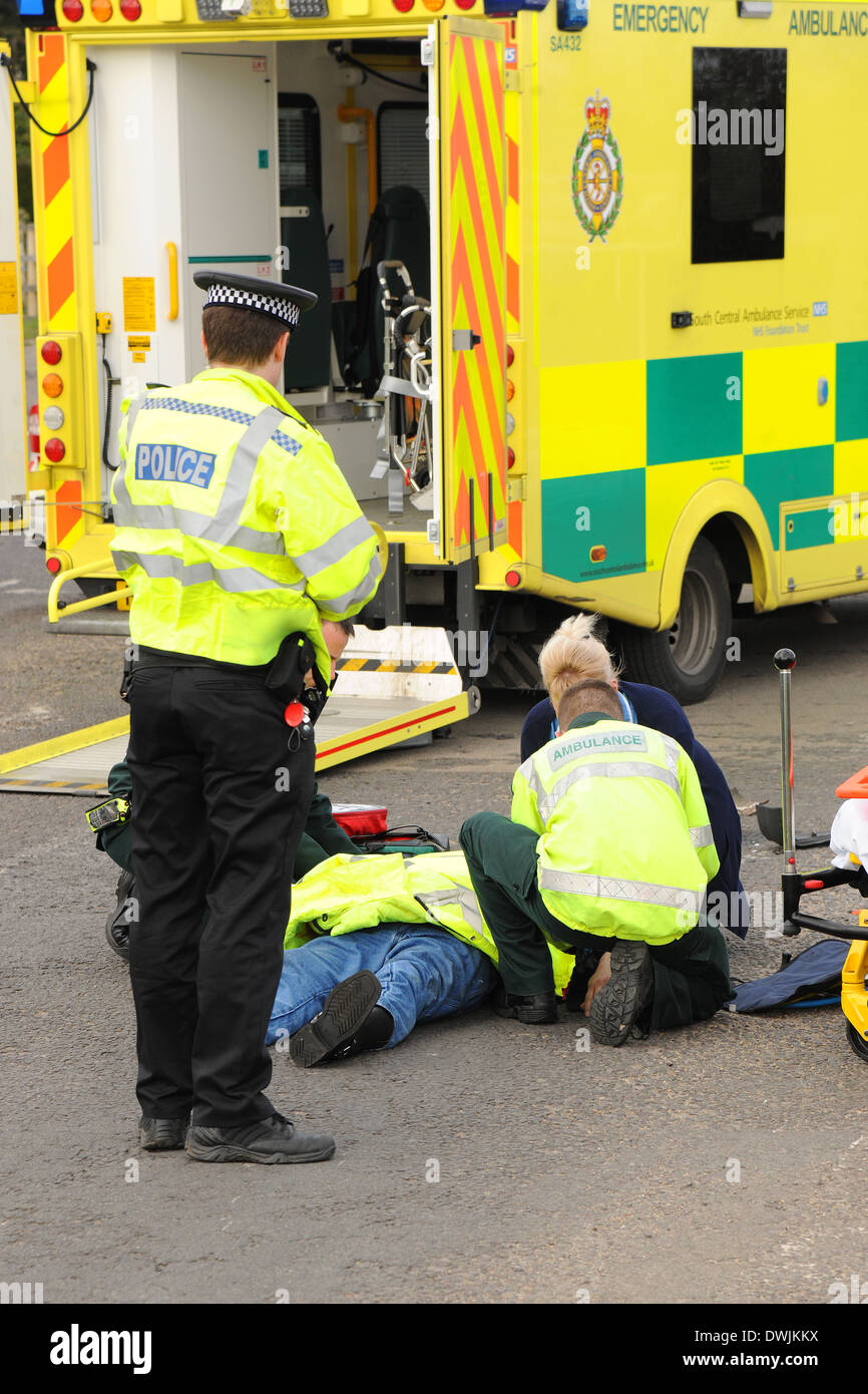 A road traffic accident casualty is tended to by ambulance crew and police officers Stock Photo