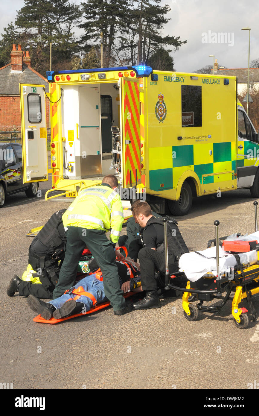 A road traffic accident casualty is tended to by ambulance crew and police officers Stock Photo