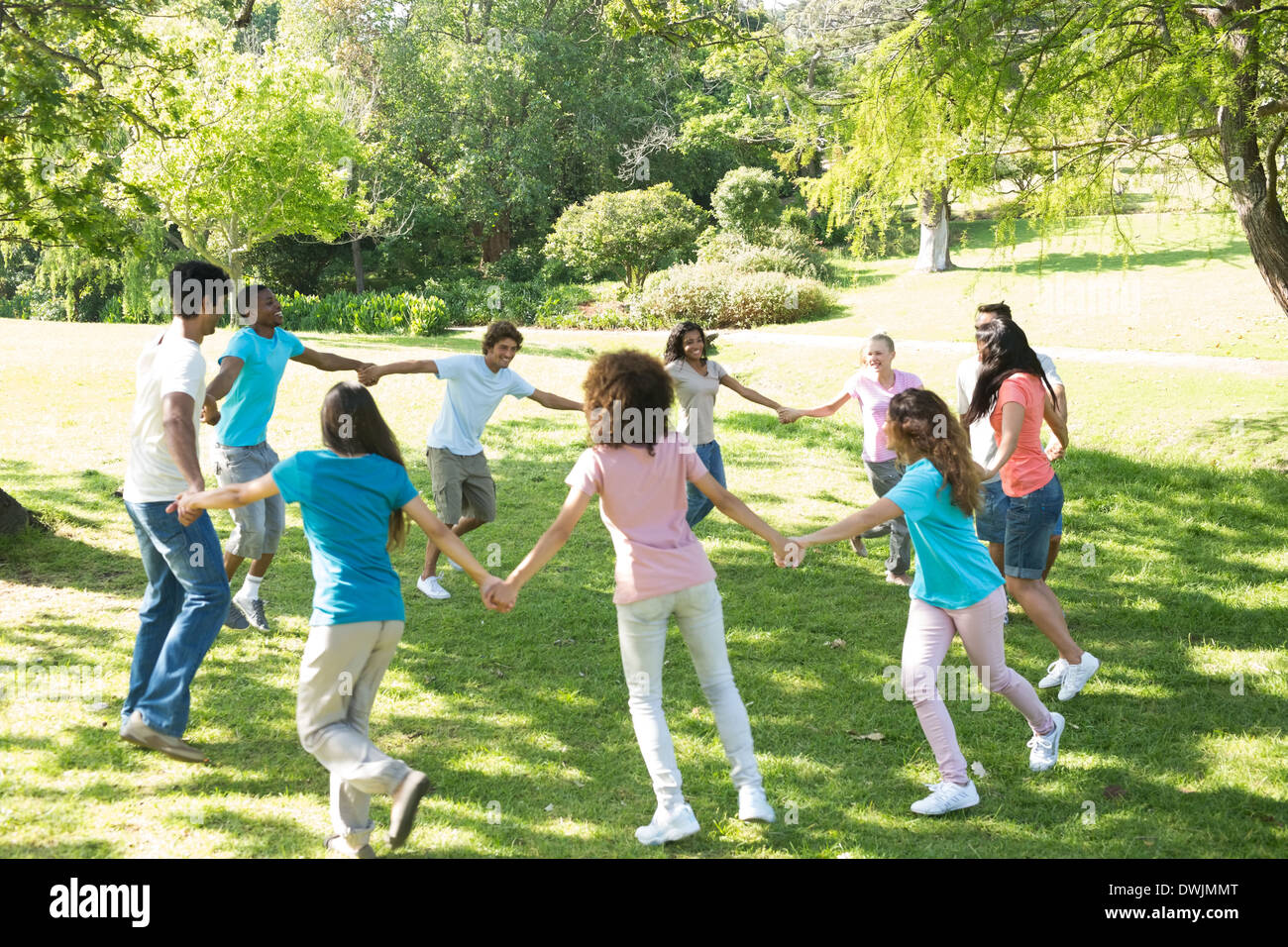 Friends walking in a circle at park Stock Photo - Alamy