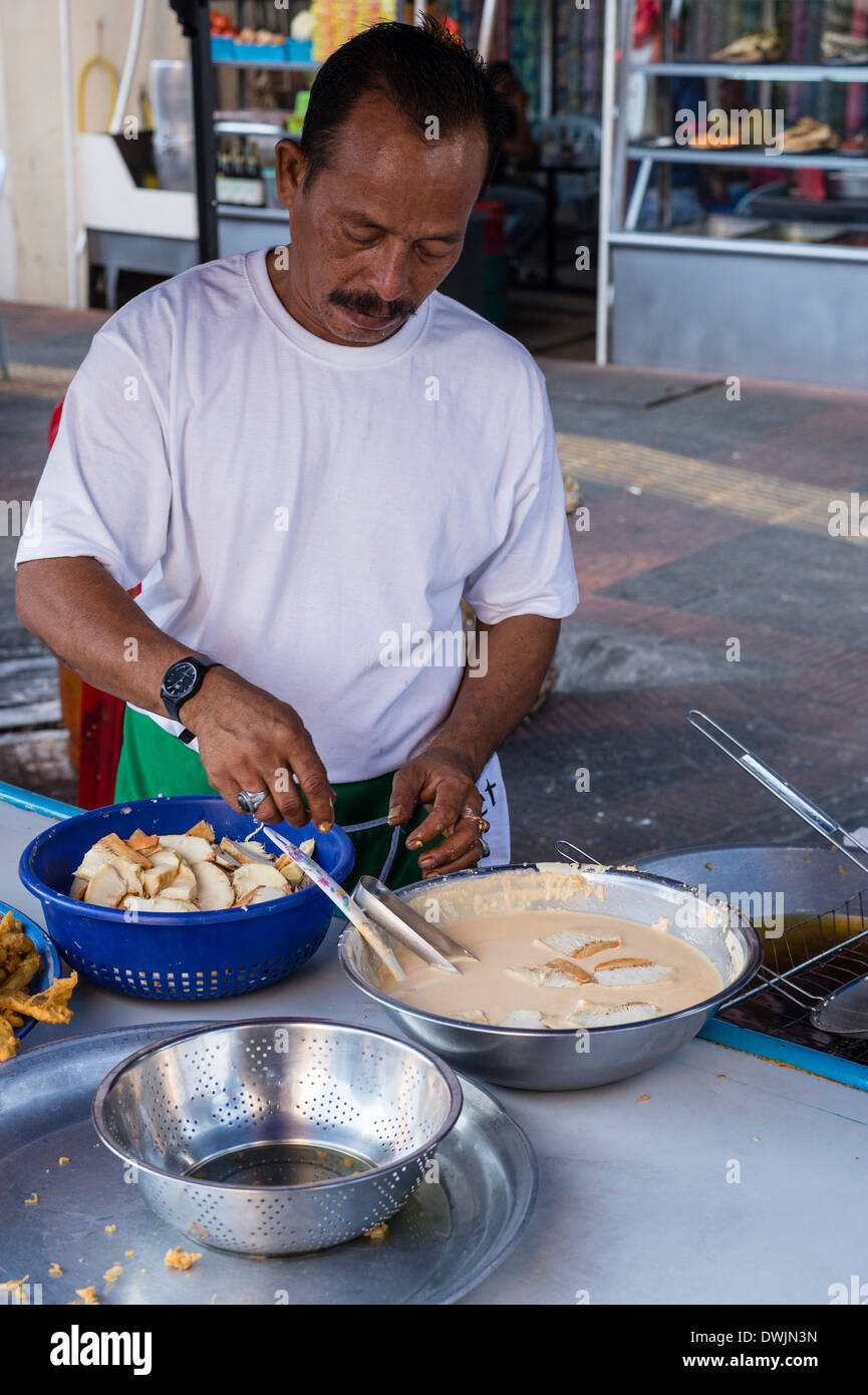 Battered chicken being cooked at a market stall Stock Photo