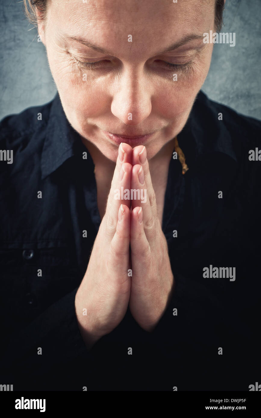 Woman praying and praising the God. Religion, spirituality concept. Stock Photo