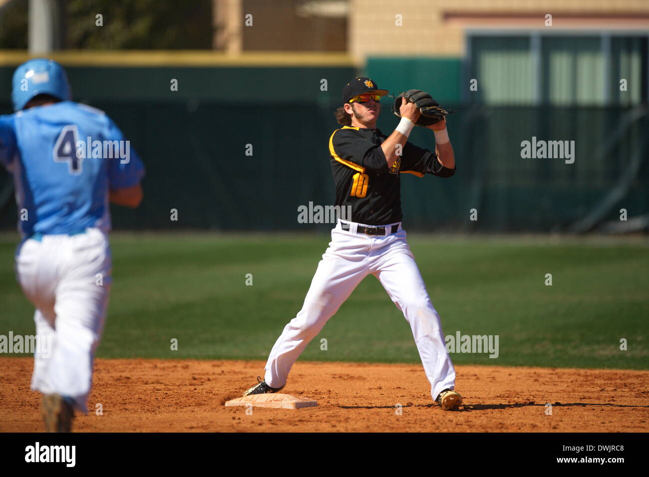 Kennesaw, Georgia, USA.  March 8, 2014 -- Shortstop Kal Simmon (KSU) turns a doubleplay during the first game of Saturday's doubleheader between Columbia University and Kennesaw State University. The teams split the doubleheader. Credit:  Wayne Hughes | Alamy Live News Stock Photo