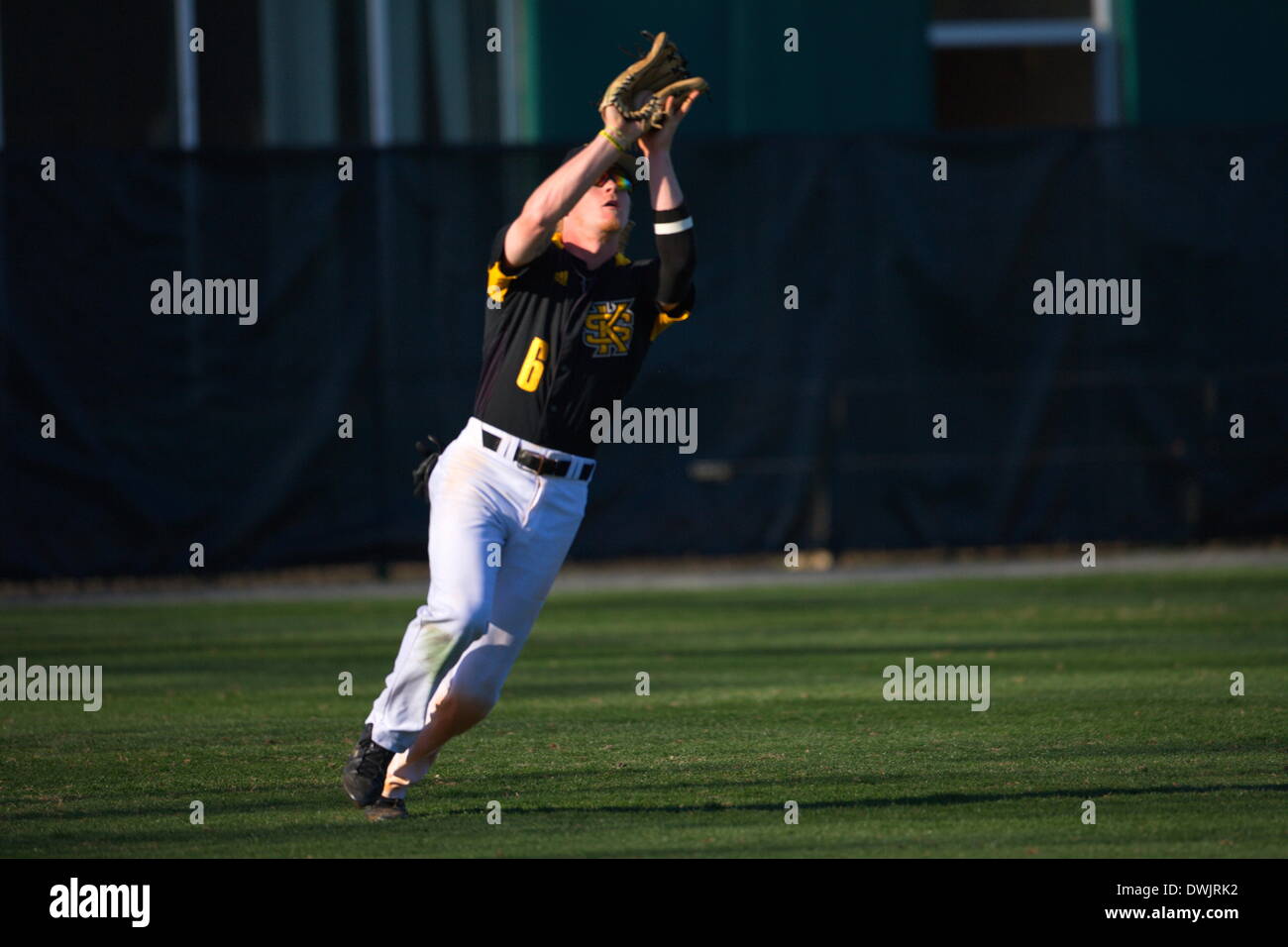 Kennesaw, Georgia, USA.  March 8, 2014 -- Jacob Bruce (6) hauls in a fly ball during Saturday's doubleheader between Columbia University and Kennesaw State University.  The teams split the doubleheader.  Columbia one the first game 9-3.  KSU won the night cap 15-1. Credit:  Wayne Hughes | Alamy Live News Stock Photo