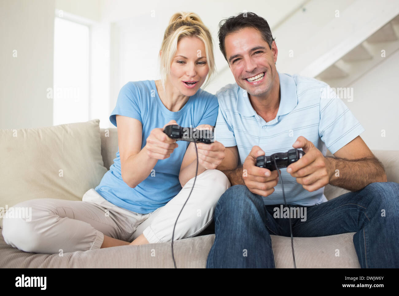 Cheerful couple play video game hi-res stock photography and images - Alamy
