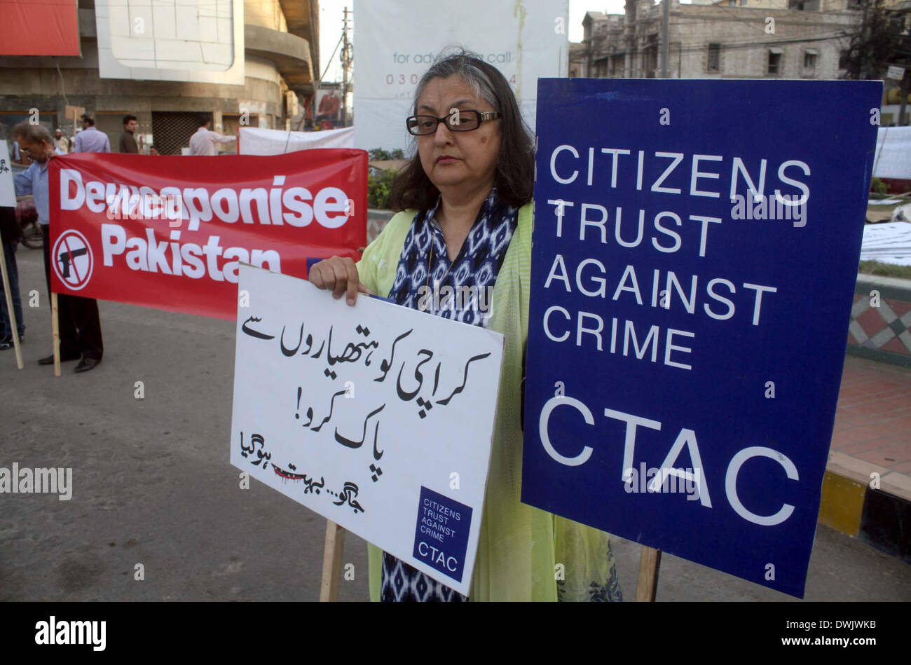 Members of NGO, Citizens Trust Against Crime (CTAC) are demonstrating in favor of peace Department while opposing terrorism, near Metro Pole Hotel in Karachi on Monday, March 10, 2014. Stock Photo