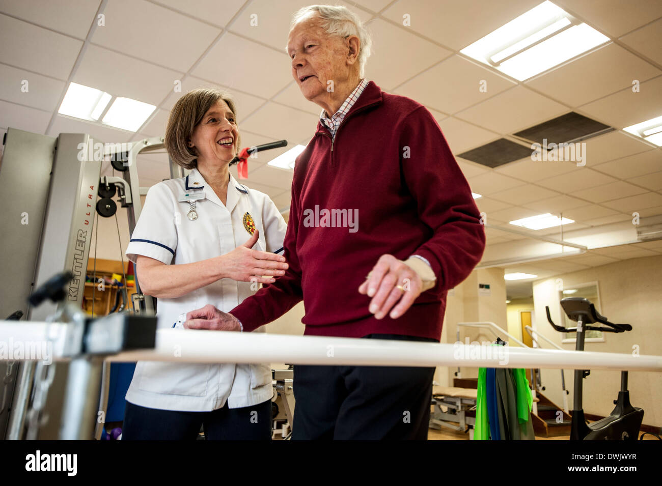 Royal Naval Reservist Stephanie Shinner Cdr RD RNR CO HMS WILDFIRE currently the only female commanding officer in The Royal Naval Reserves. Pictured at The Chiltern Hospital Bucks / BMI Healthcare where she is a consultant physiotherapist . She is pictured in consultation with 93 year old John Mason 93 who she has been seeing for over three years. Stock Photo
