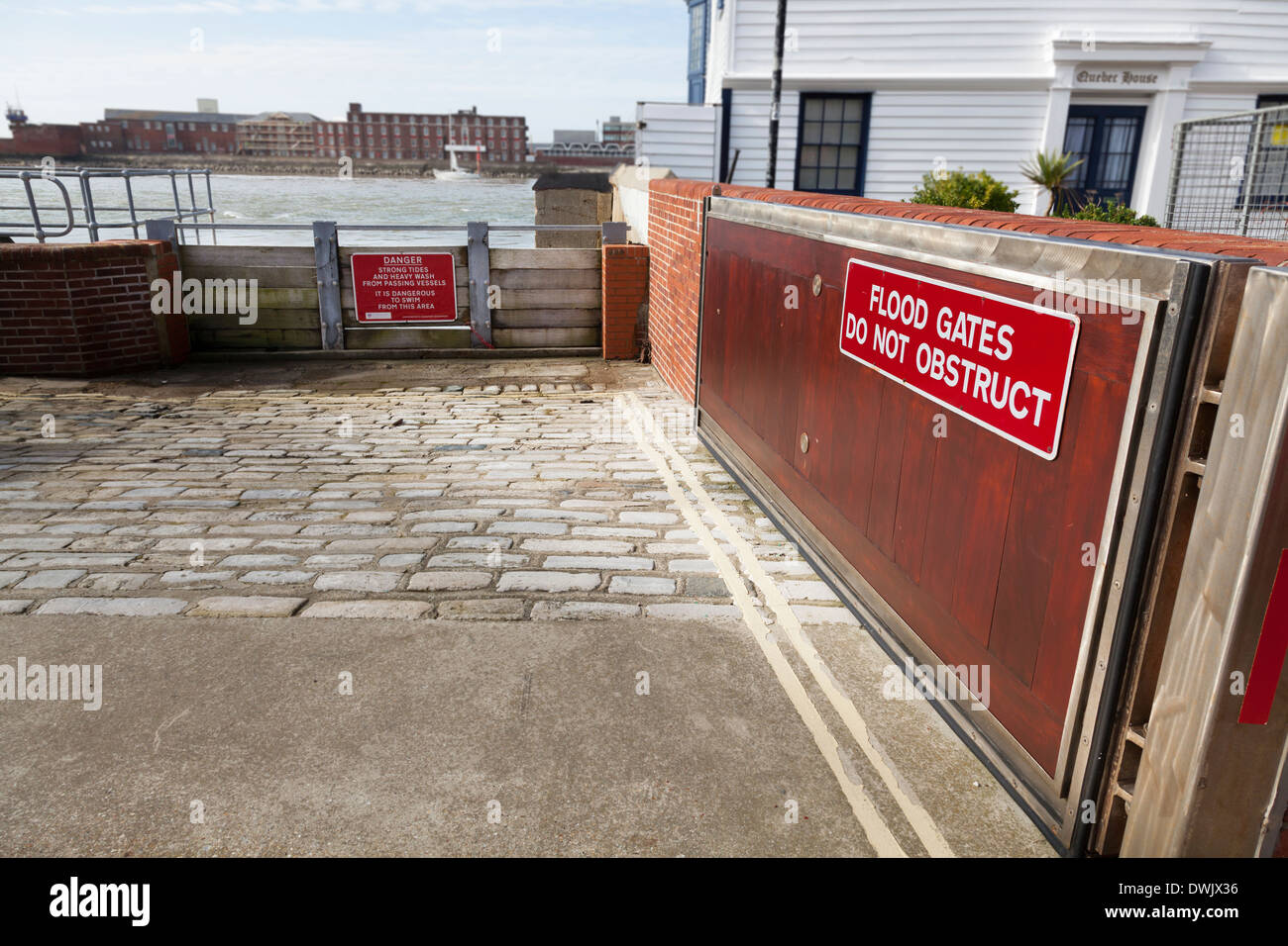 Flood gates with sign protecting Old Portsmouth from Portsmouth Harbour. Stock Photo