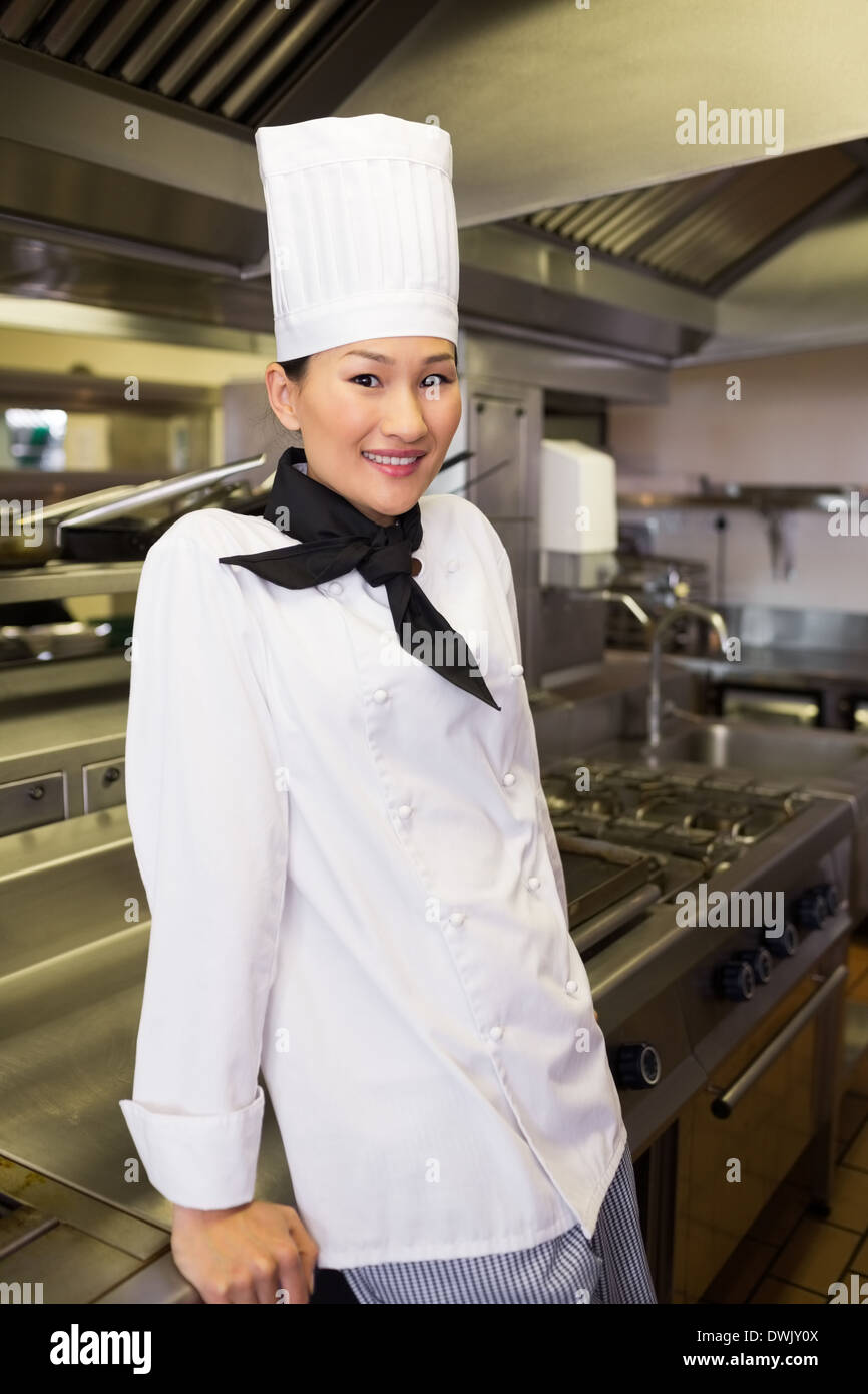 Smiling female cook in kitchen Stock Photo