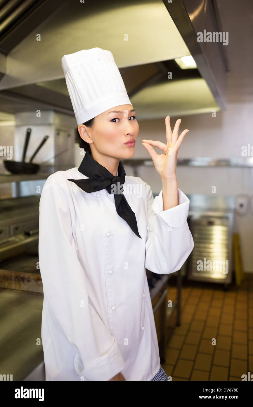 Smiling female cook in the kitchen Stock Photo