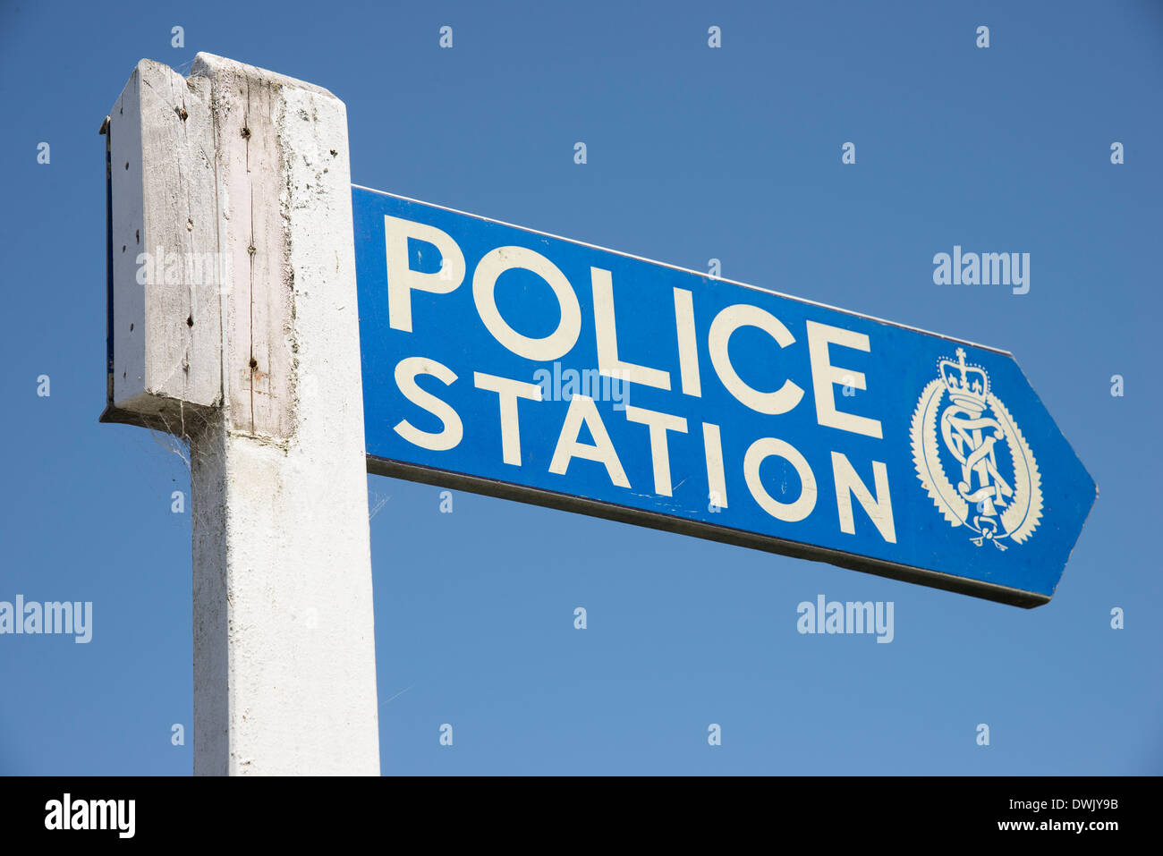 Wooden sign post pointing towards Police Station New Zealand Stock Photo