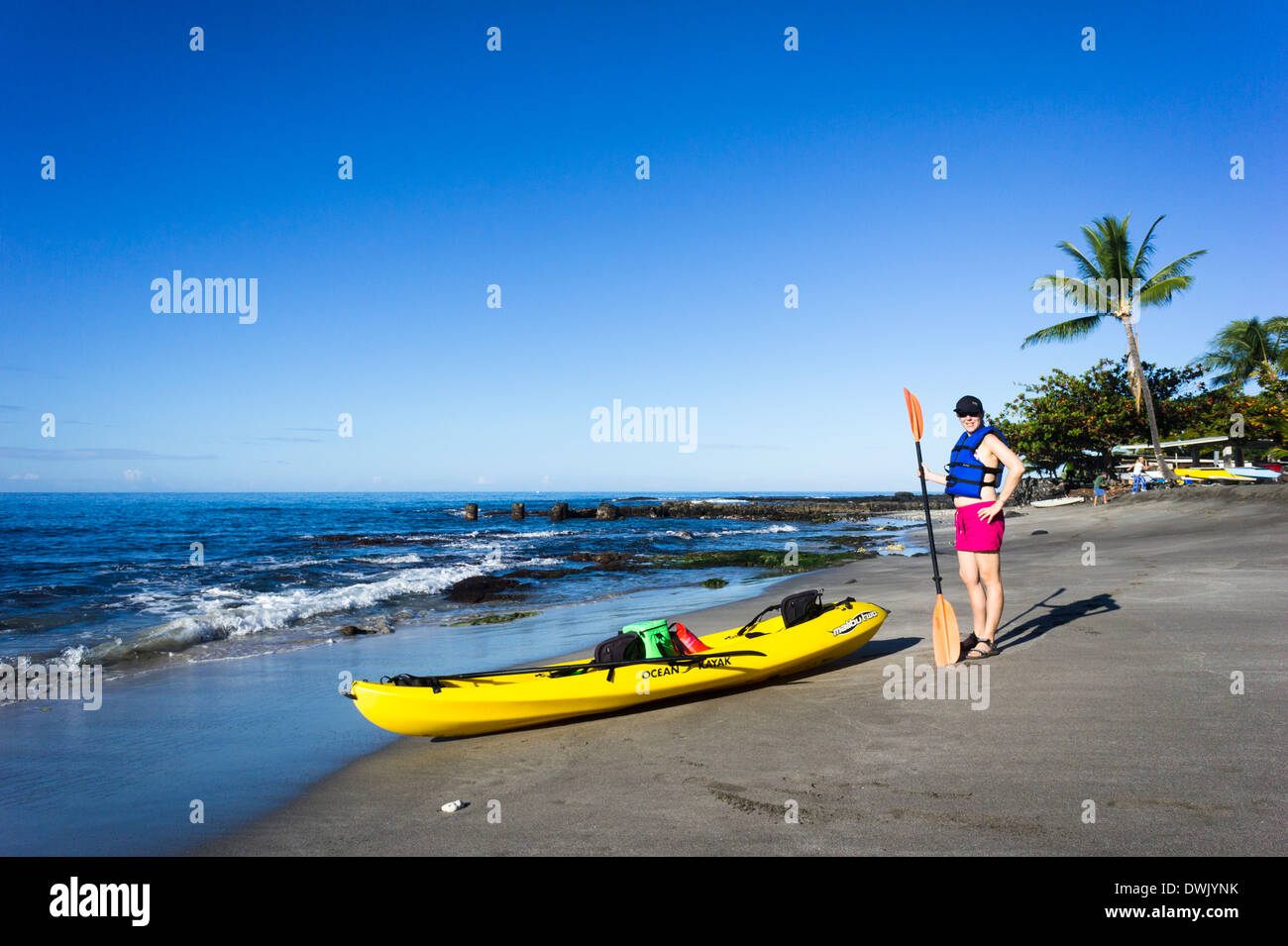 Girl with kayak on beach. Ho'okena Beach Park, The Big Island, Hawaii