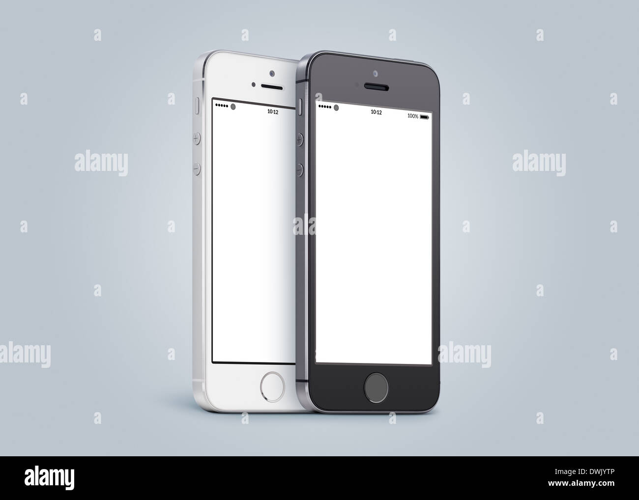 Black and white smartphones are close to each other in half turn and rotated at a slight angle on gray gradient background. Stock Photo