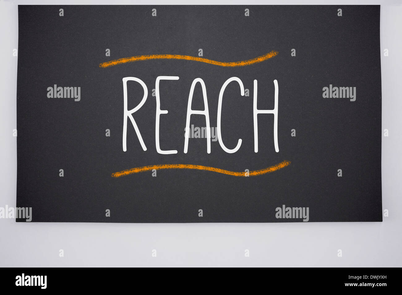 Reach written on big blackboard Stock Photo