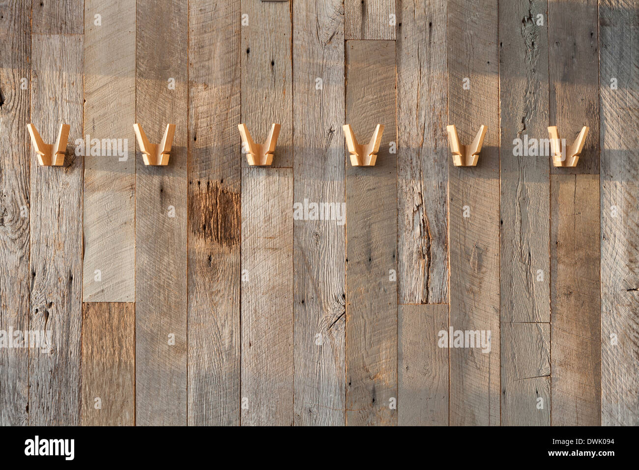 Wooden coat hangers on wooden reclaimed wall Stock Photo Alamy