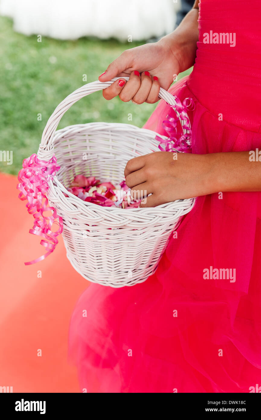 Flower girl with a basket of flower petals Stock Photo