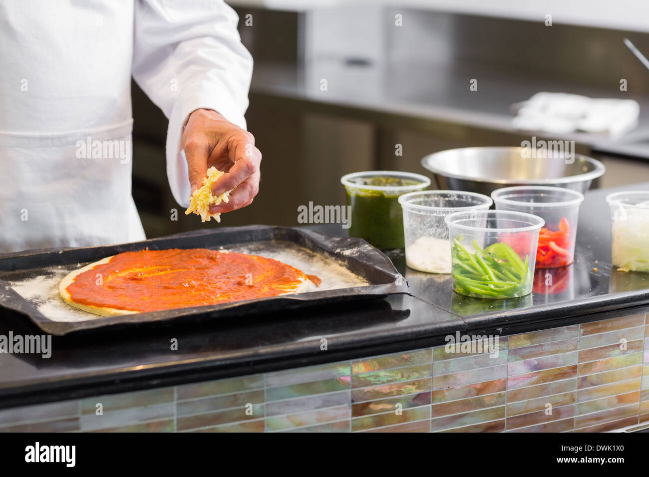 Mid section of chef garnishing food in kitchen Stock Photo