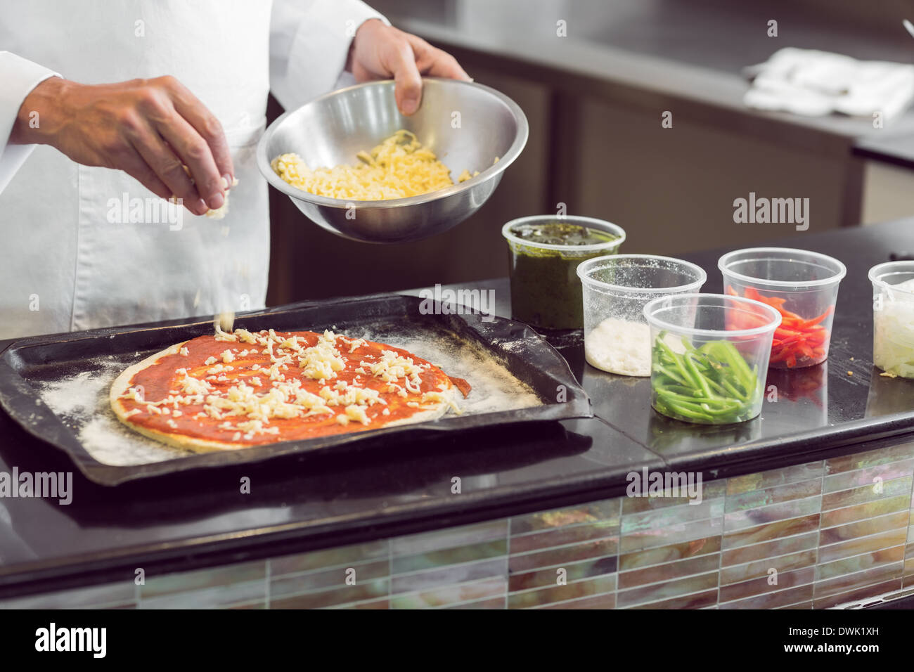 Mid section of a chef garnishing food in kitchen Stock Photo