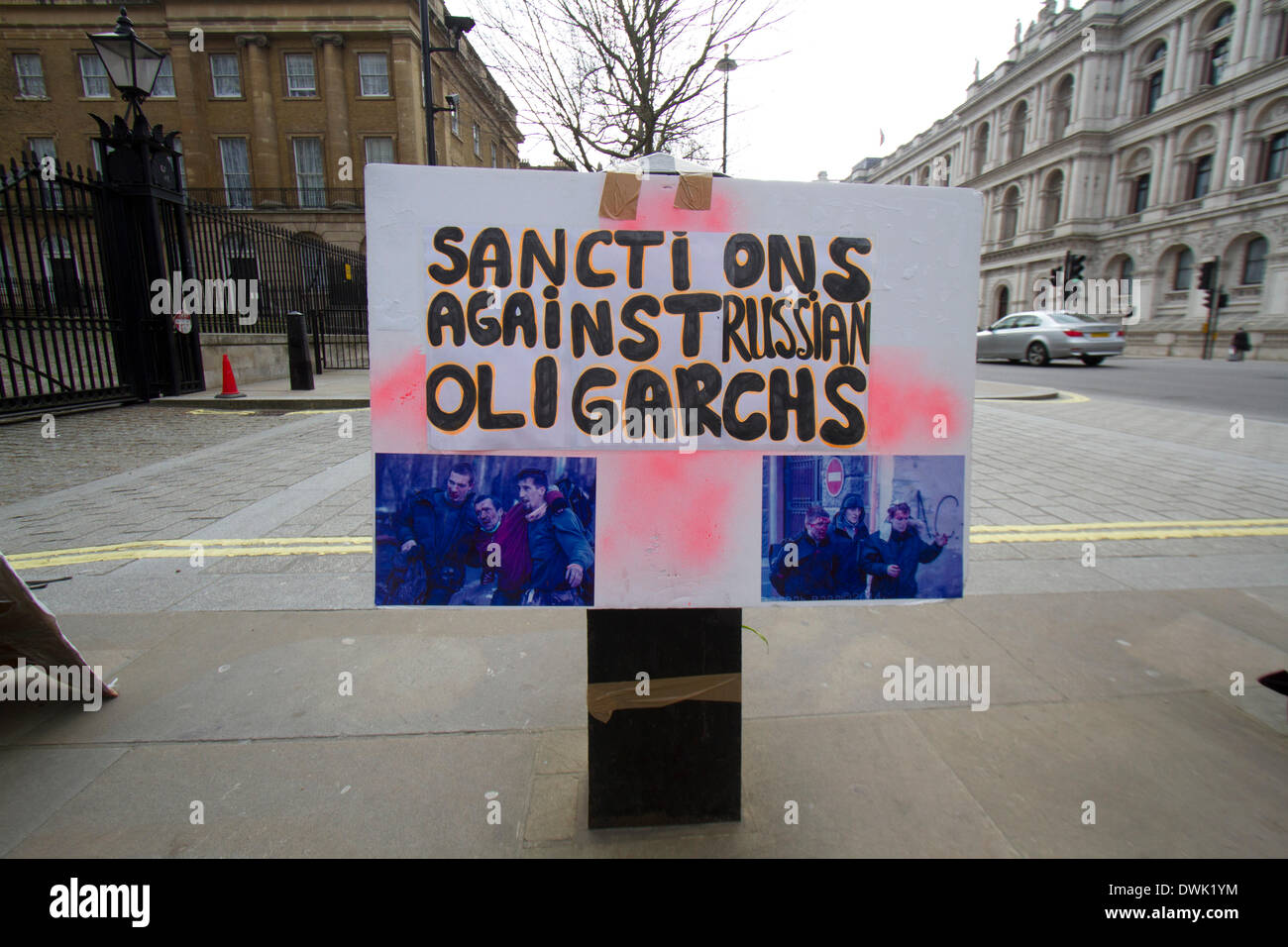 Westminster London ,UK. 10th March 2014. Ukrainian protesters continue to hold a 24hour shift protest outside Downing Street with placards following the Russian military intervention in the Crimea demanding on the British Government to keep its promises on the Budapest memorandum on Security Assurances signed in 1994.The Memorandum included security assurances against threats or use of force against the territorial integrity or political independence of Ukraine and as a result Ukraine gave up its stockpile of Nuclear weapons between 1994 and 1996. Credit:  amer ghazzal/Alamy Live News Stock Photo