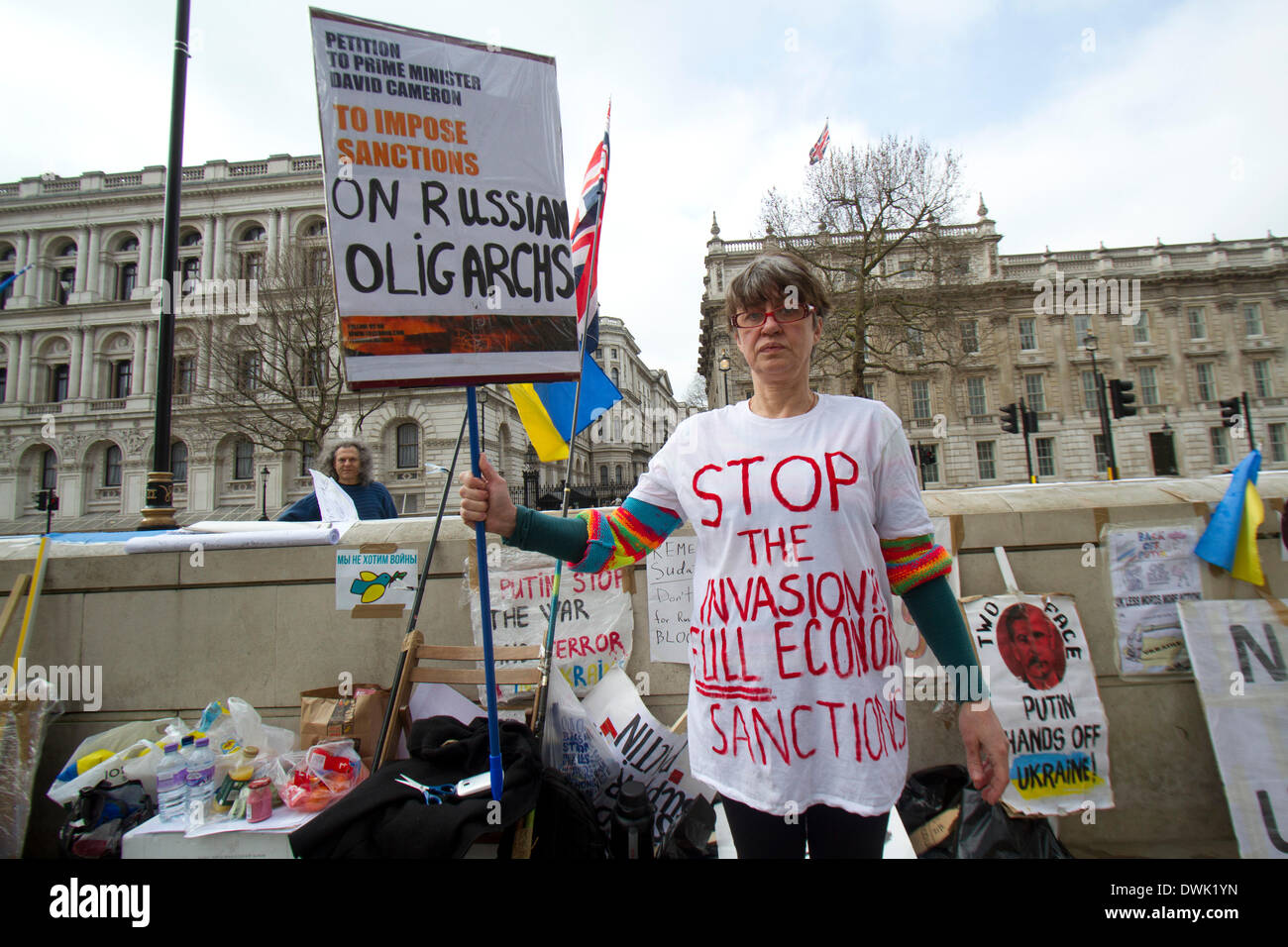 Westminster London ,UK. 10th March 2014. A Ukrainian protester with placard outside Downing Street demanding British Prime Minster David Cameron impose economic sanctions on Russian oligarchs in Britain following the Russian military intervention in Crimea Credit:  amer ghazzal/Alamy Live News Stock Photo