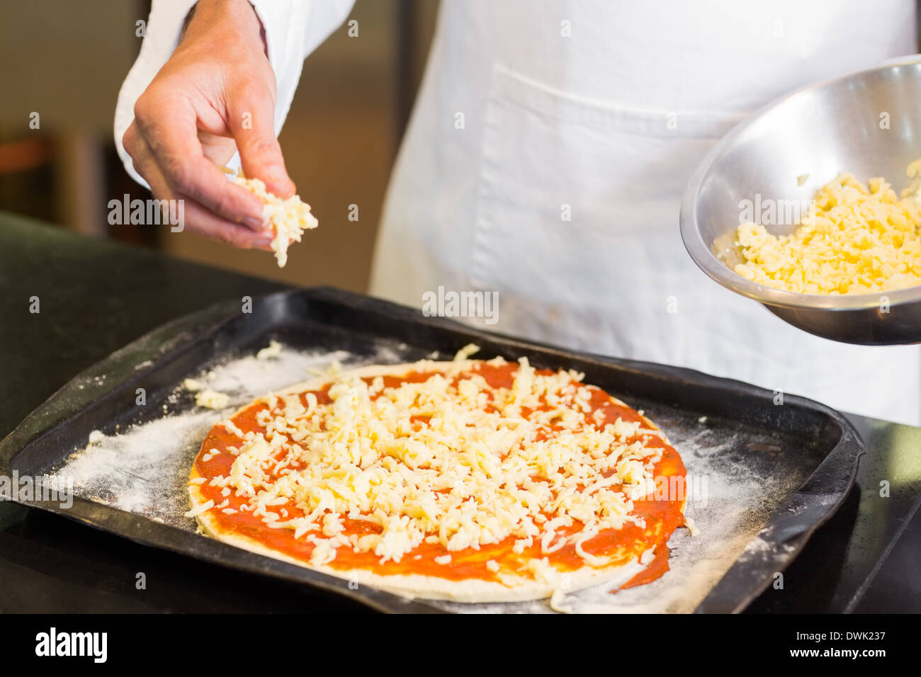Mid section of a chef preparing pizza Stock Photo