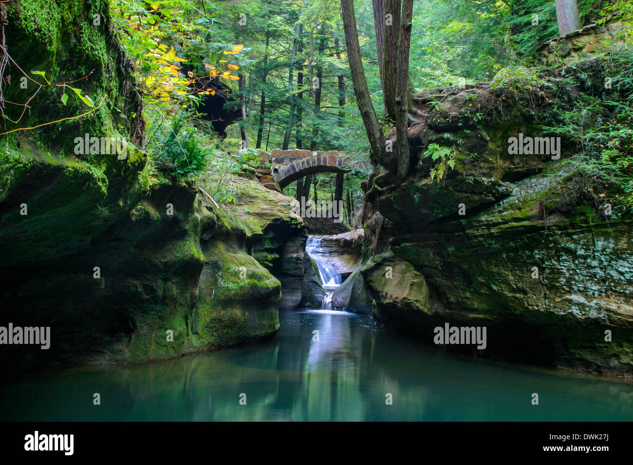 a small stone foot bridge and waterfall through the scenic gorge waterfall bridge