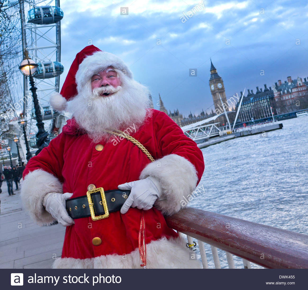 A jovial Father Christmas on the SouthBank with London Eye and Houses