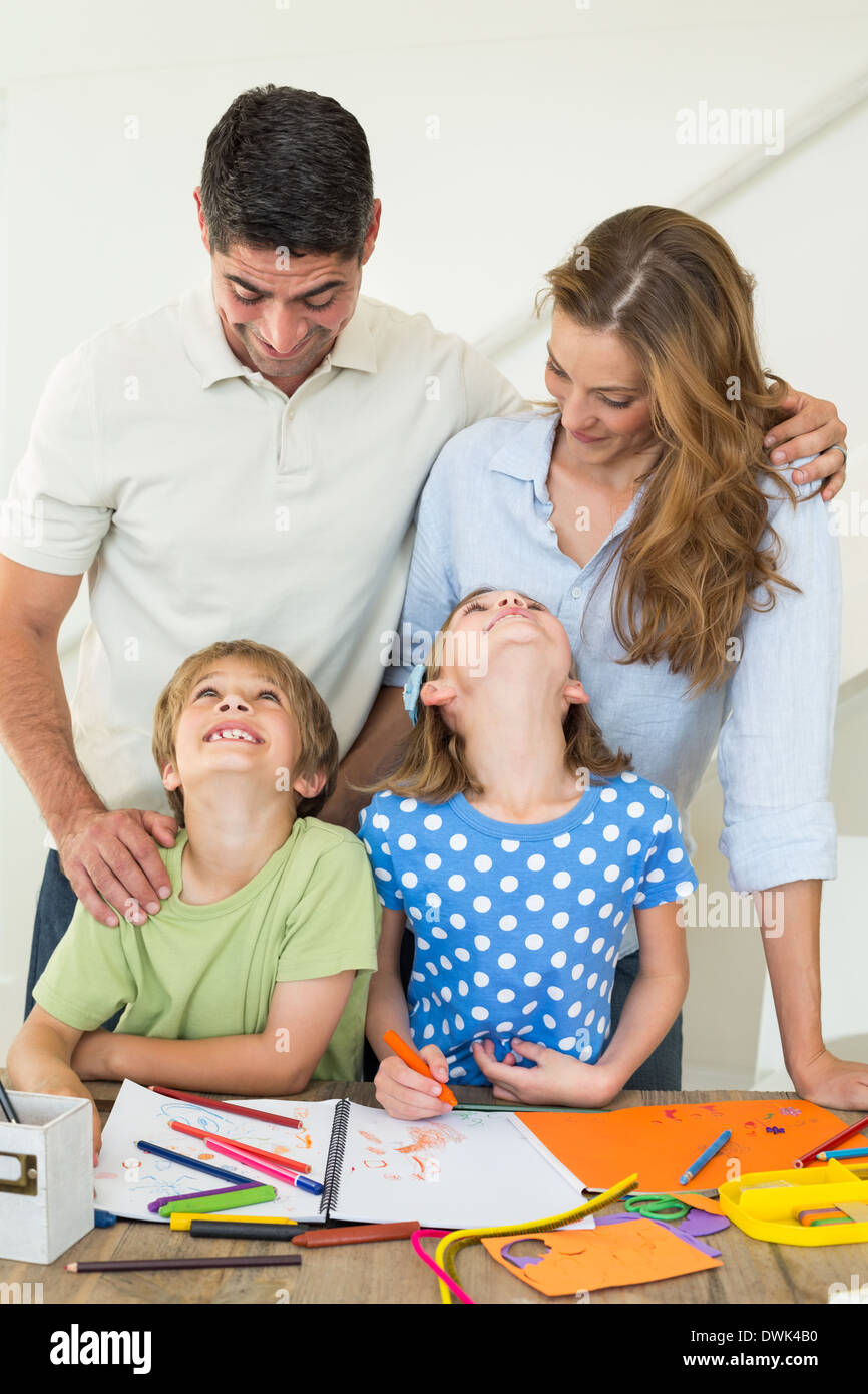 Family of four coloring at home Stock Photo - Alamy