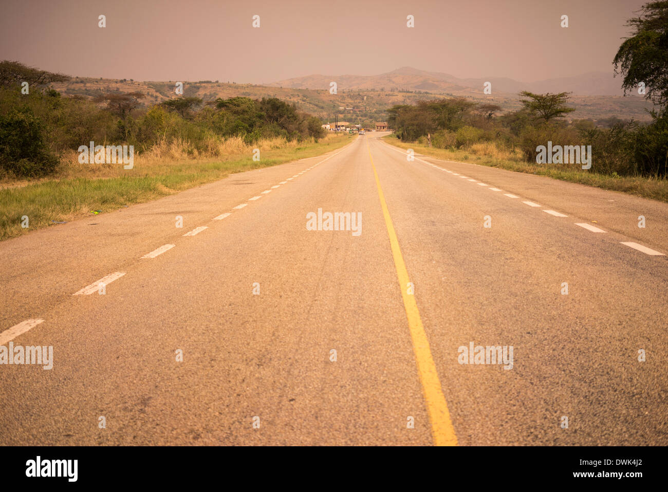 Road leading to a beautiful landscape in Uganda Africa at the equator. Stock Photo