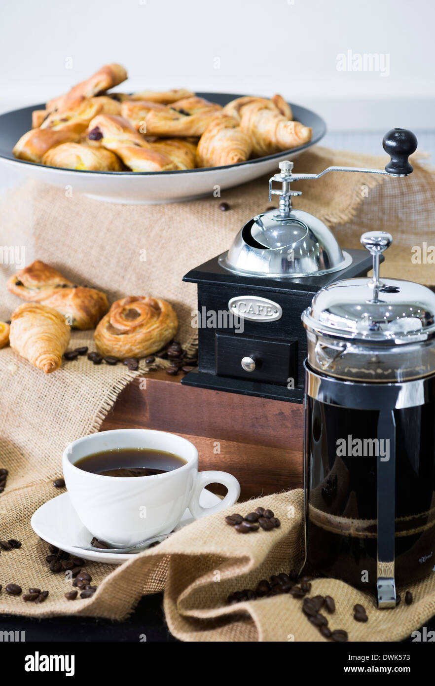 Vintage coffee grinding machine with brewed coffee and a cup Stock