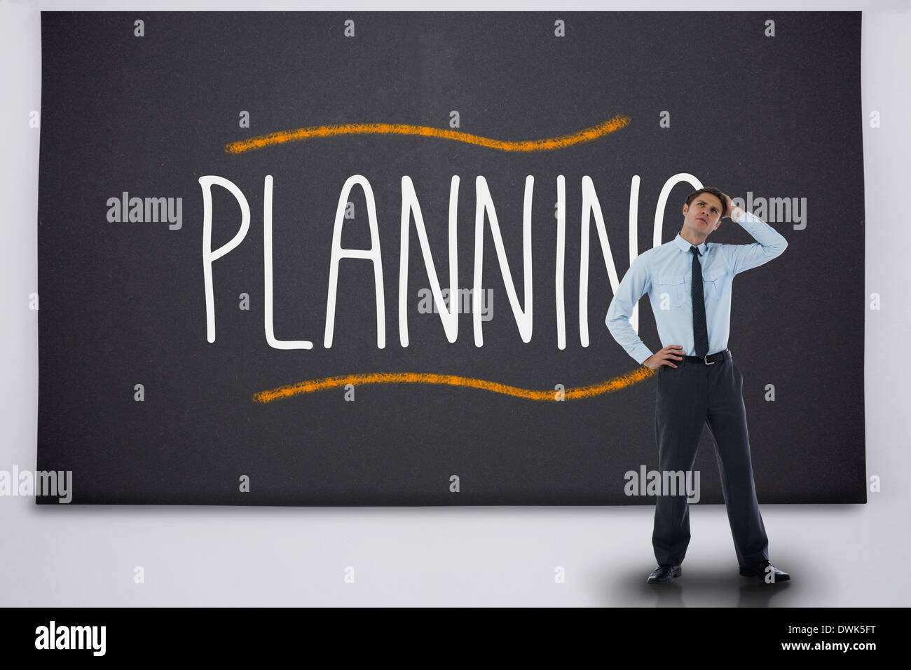 Businessman thinking against the word planning Stock Photo