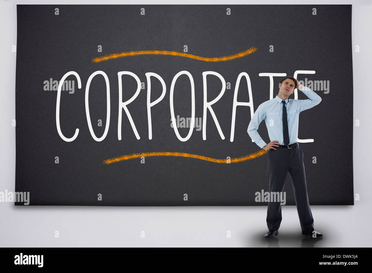 Businessman thinking against the word corporate Stock Photo