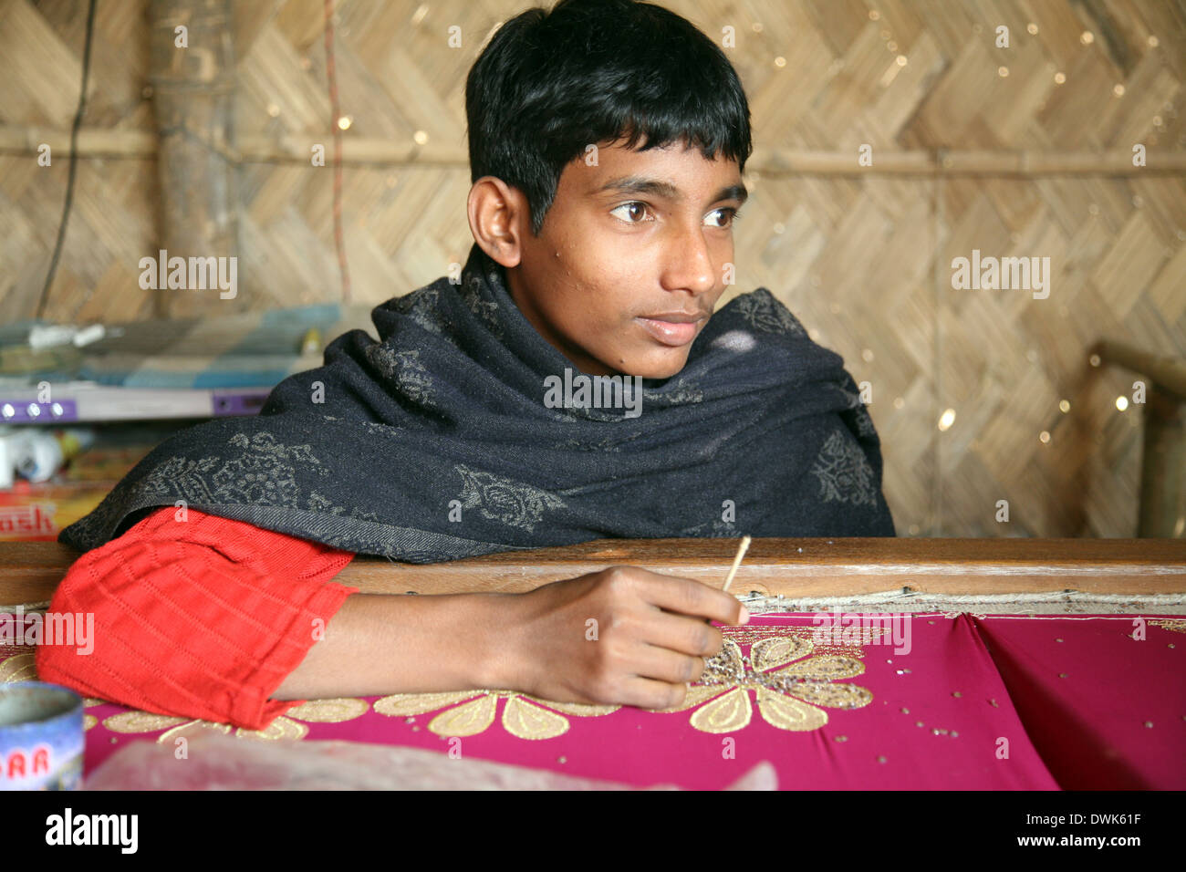 Teenager working on the decoration of textiles in Kumrokhali, India on Jan 16, 2009. Stock Photo