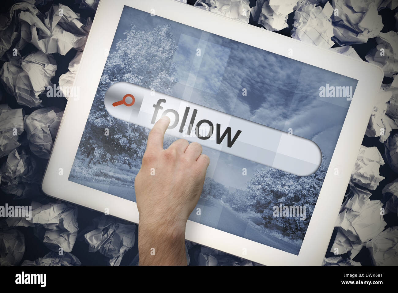 Hand touching follow on search bar on tablet screen Stock Photo