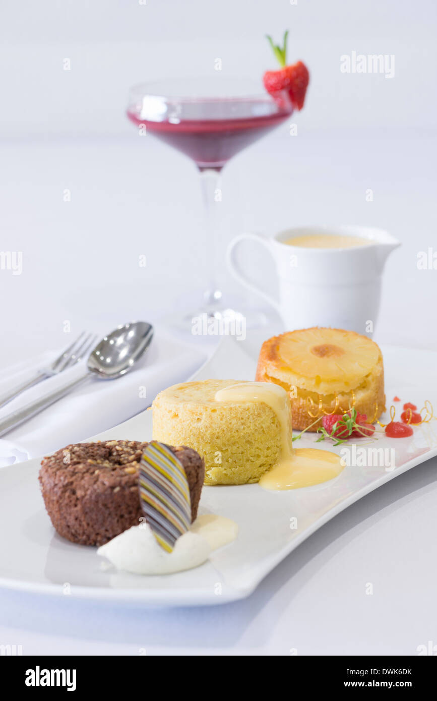 Trio of desserts, including chocolate brownie, sponge pudding and queen
