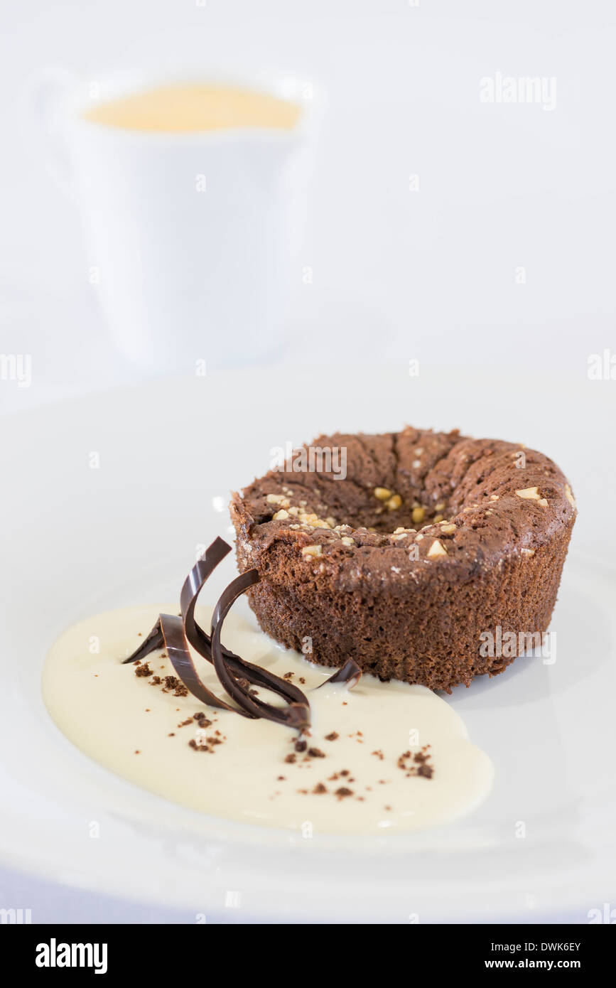 Chocolate brownie pudding with custard Stock Photo Alamy