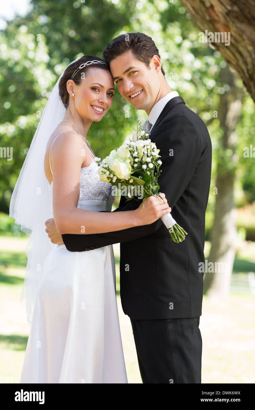 Newly wed couple with head to head in garden Stock Photo - Alamy