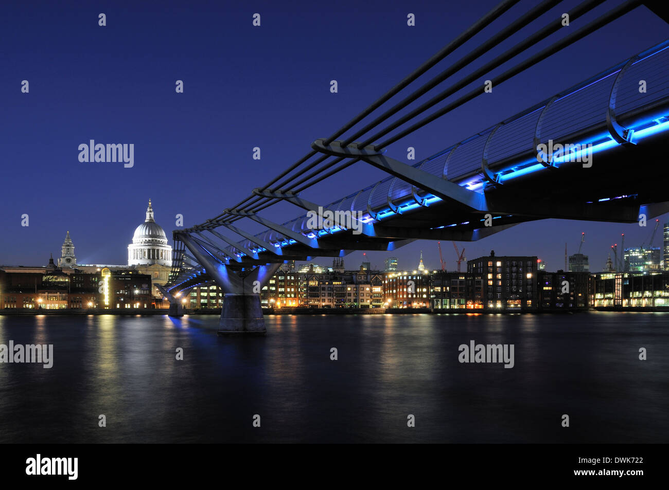 The Millennium Bridge, London UK, at night, with St Paul's Cathedral dome Stock Photo